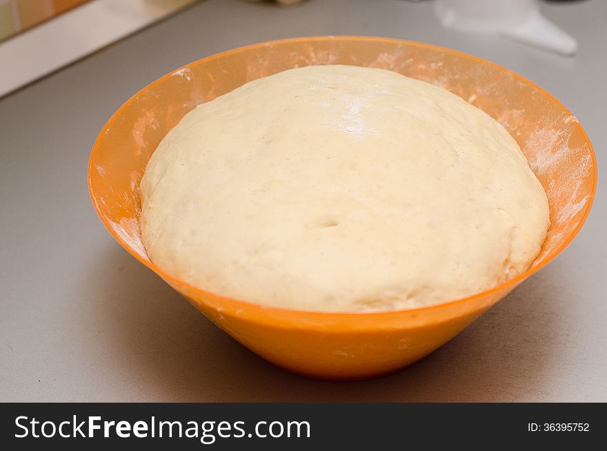 Leavened dough in a plastic bowl