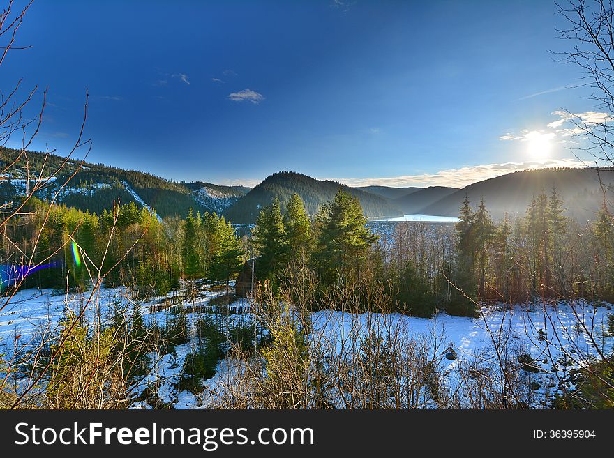 Winter Landscape With Lake, Forest And Sun.