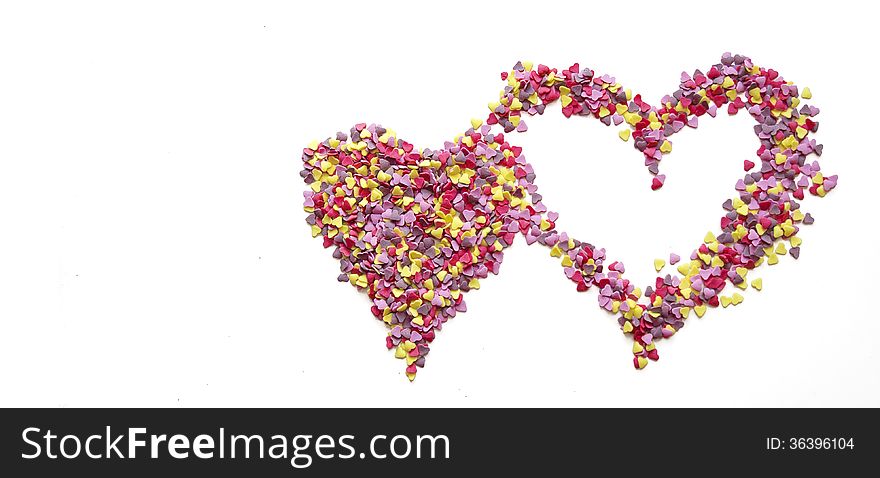 Pink heart made of candys on white background. Pink heart made of candys on white background