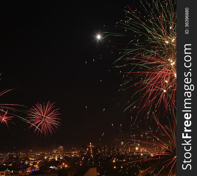 New year's eve fireworks in the city of Arequipa, Peru. Square image with moon in the picture. New year's eve fireworks in the city of Arequipa, Peru. Square image with moon in the picture