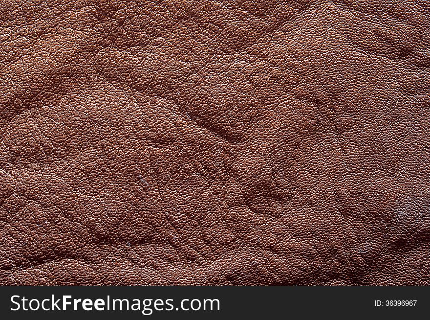 Natural brown leather texture closeup on a table.