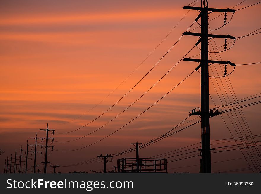 Electricity cable communication towers on sunset stretching across the river. Electricity cable communication towers on sunset stretching across the river.