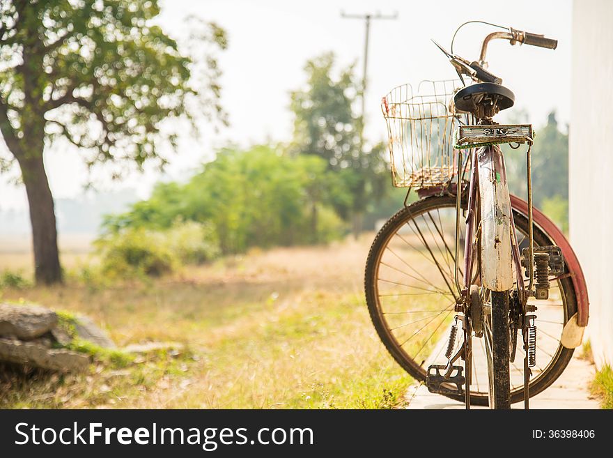 Old bicycle on the side of the house for background. Old bicycle on the side of the house for background.