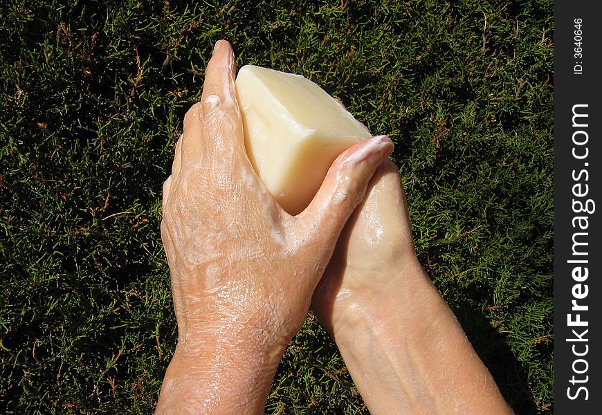 soapy hands on a green background