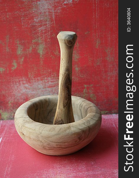 Wooden mortar with red background ,