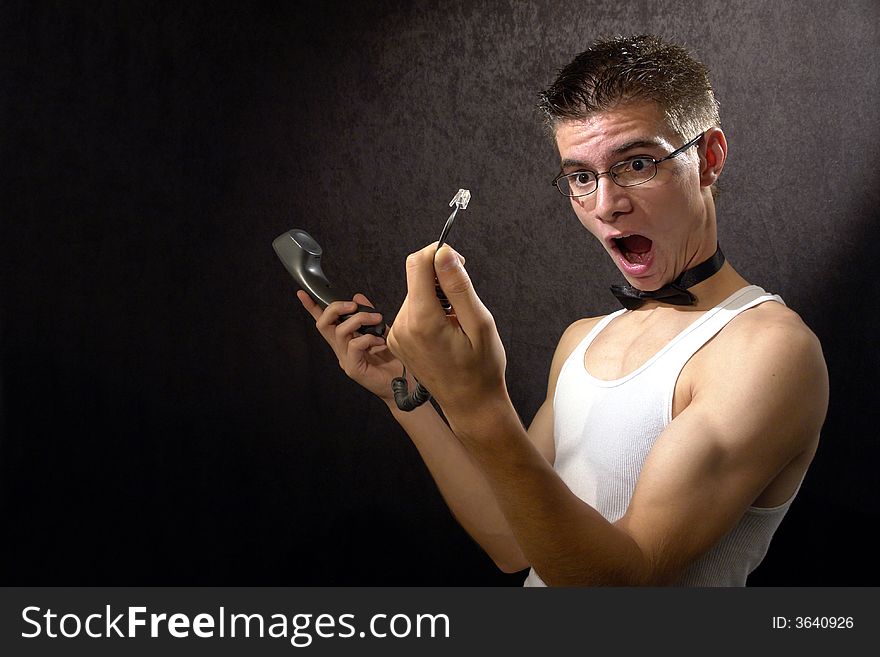 Studio portrait of guy in white shirt with a phone. Studio portrait of guy in white shirt with a phone