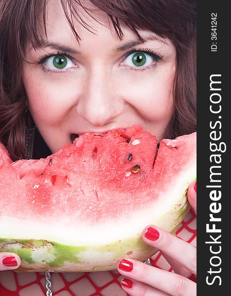 The girl eats a red water-melon
