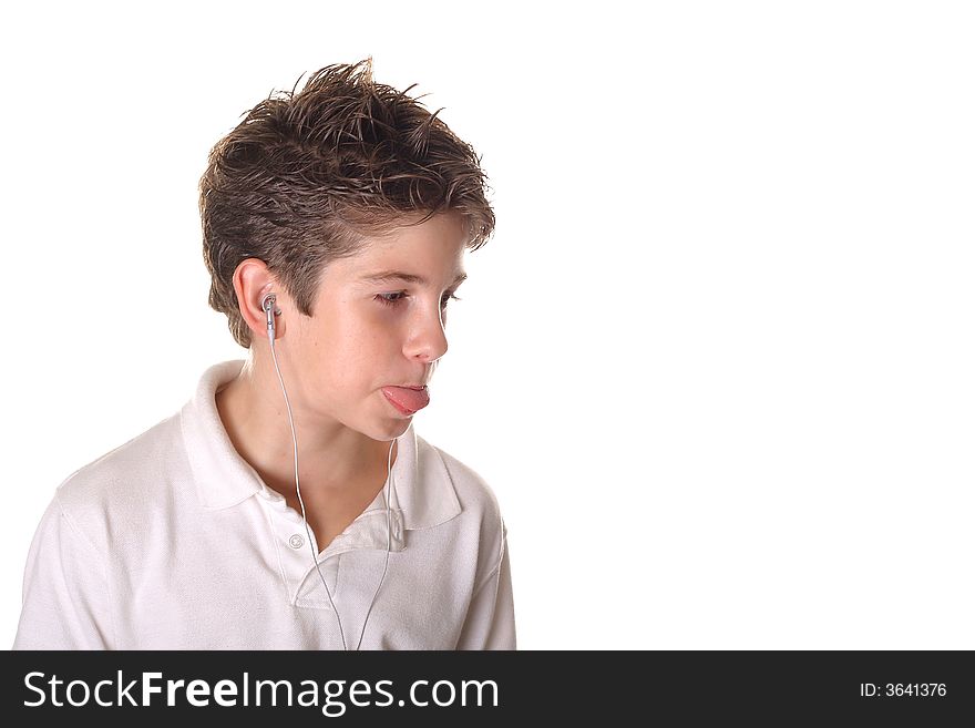Shot of a young boy listening to music sticking out his tongue