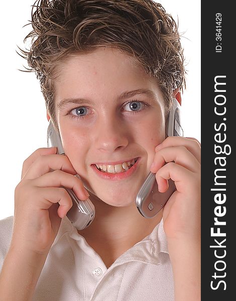 Shot of a young boy talking on two cell phones upclose vertical