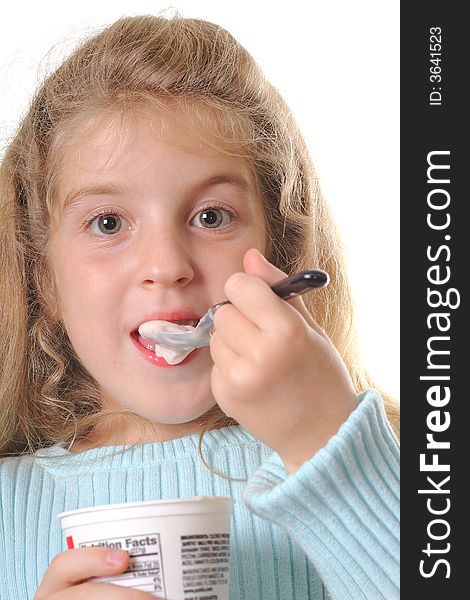 Shot of a young girl eating yogurt vertical