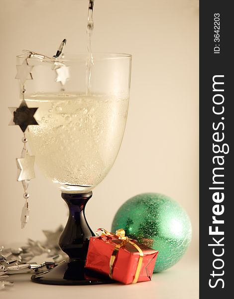 Christmas champagne glass with silver decoration and toys