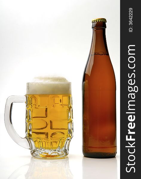 Fresh golden beer in a mug on a white background