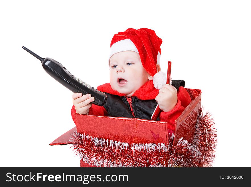 Infant calling by phone in the decorated christmas box. Infant calling by phone in the decorated christmas box