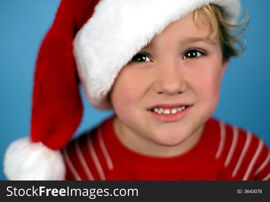 A Young Boy Wearing A Santa Hat