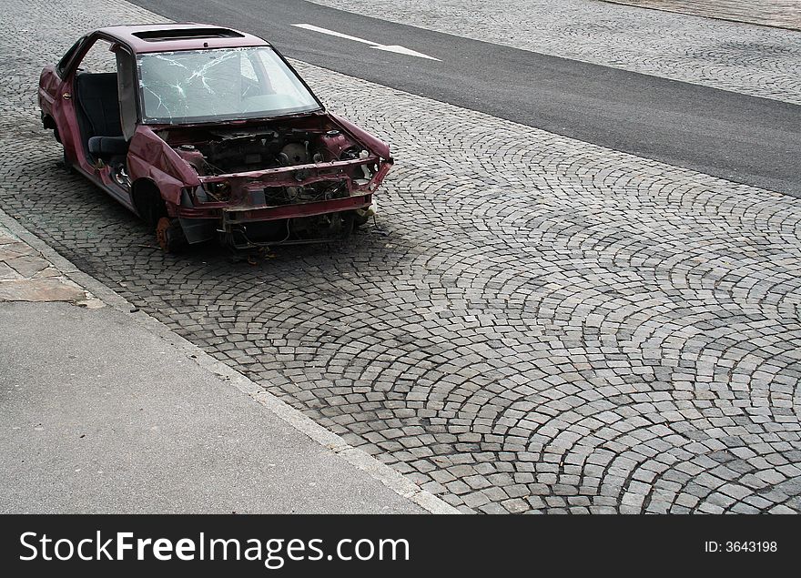 Busted car wreck, found on a parking site near the highway