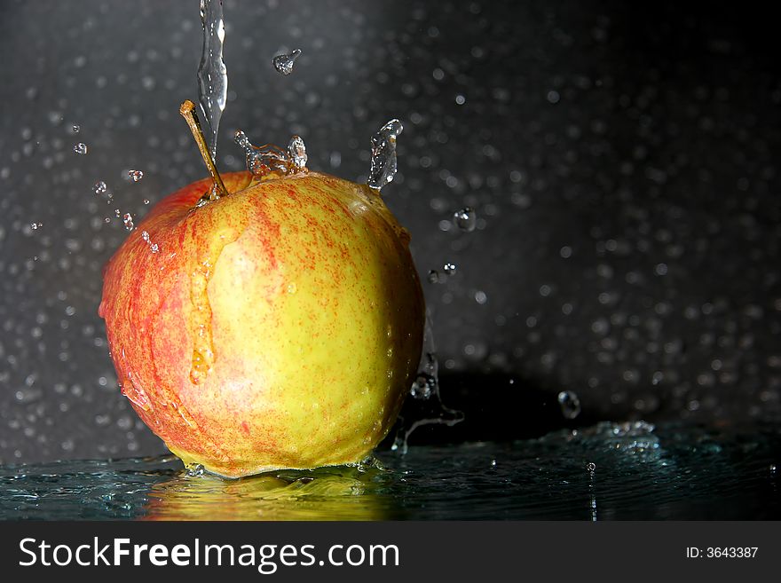 The wet fresh apple with little drops