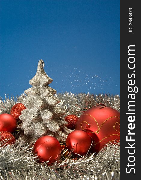 Silver christmas tree surrounded by red globes. Silver christmas tree surrounded by red globes