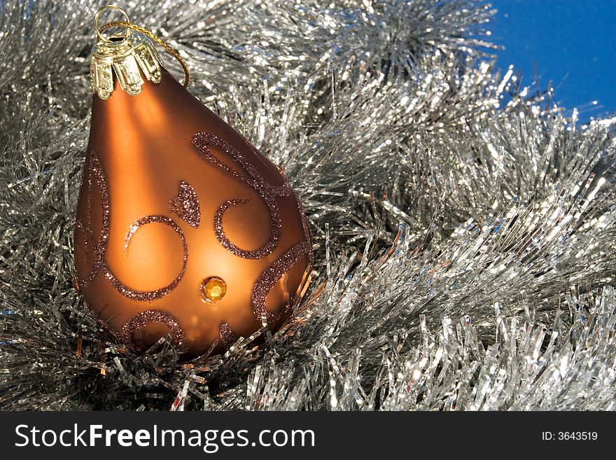 Golden classic christmas globe on silver feathers. Golden classic christmas globe on silver feathers