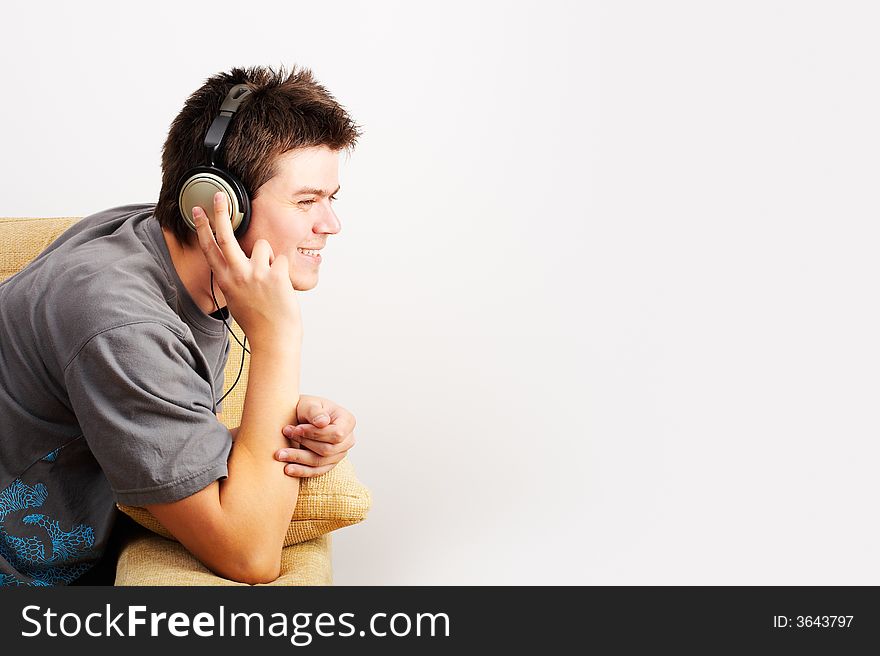 Young Man enjoys listening music in headphones