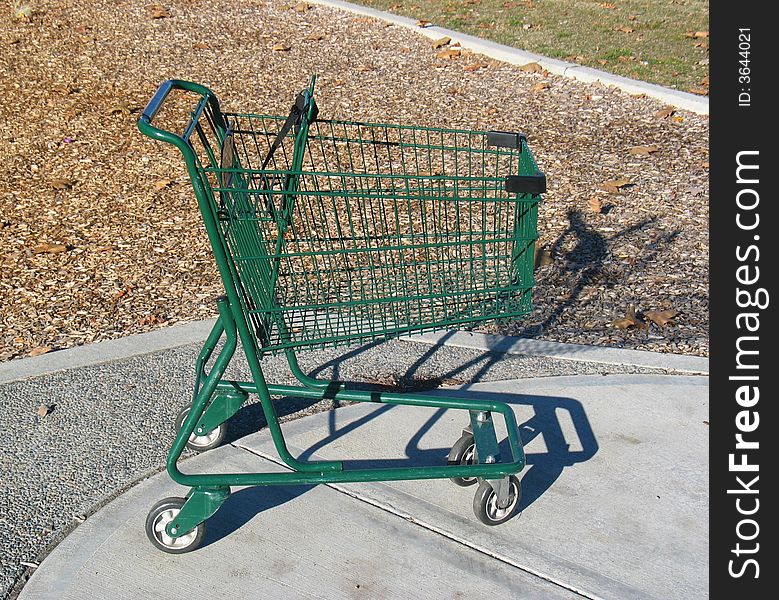 A green shopping cart in the playground.