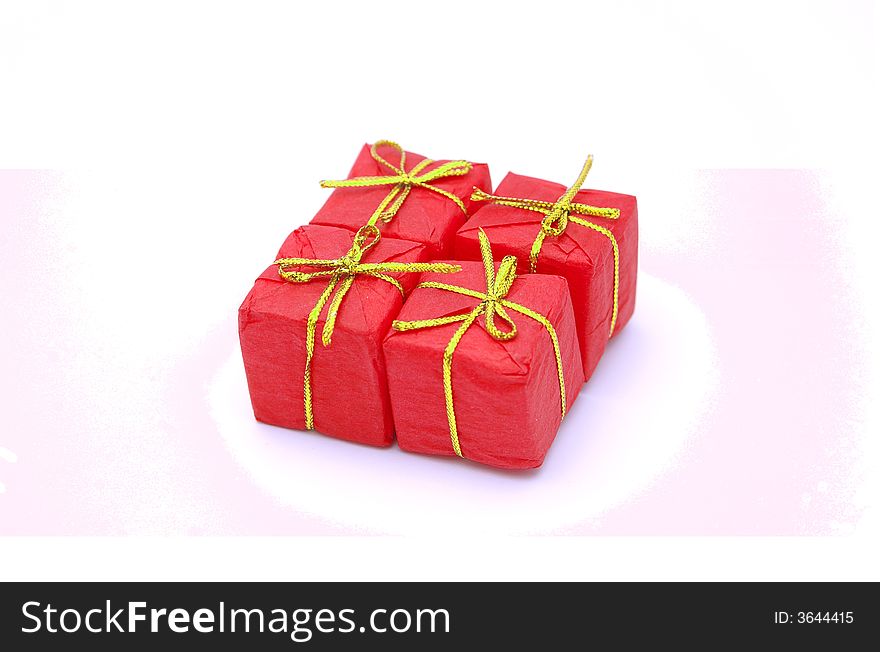 Four red gift boxes with golden ribbons