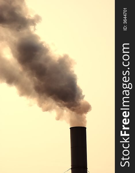 Smokestack belching out grey smoke