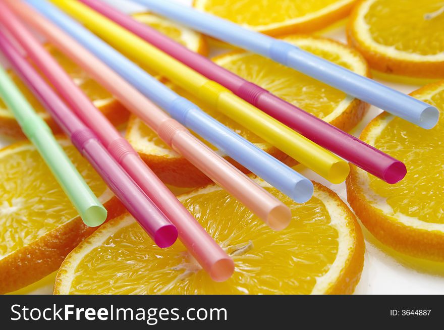 Straw on juicy citrus slices. Straw on juicy citrus slices