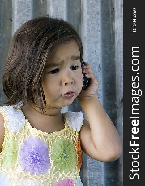 Little girl talking on the phone. Little girl talking on the phone