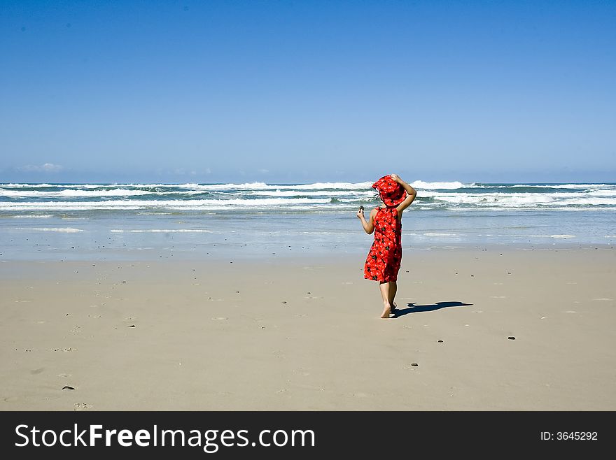 Girl in red dress on the beach. Girl in red dress on the beach