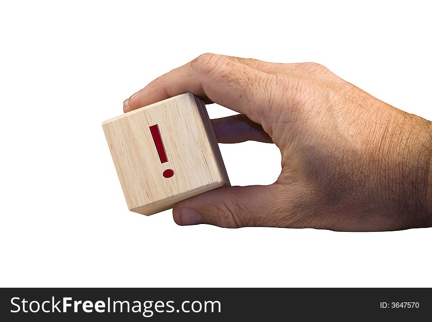 Single hand holding wooden block with exclamation sign