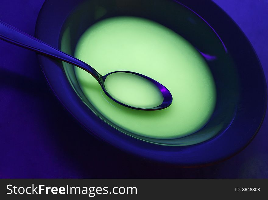 Plate and tablespoon over blue background