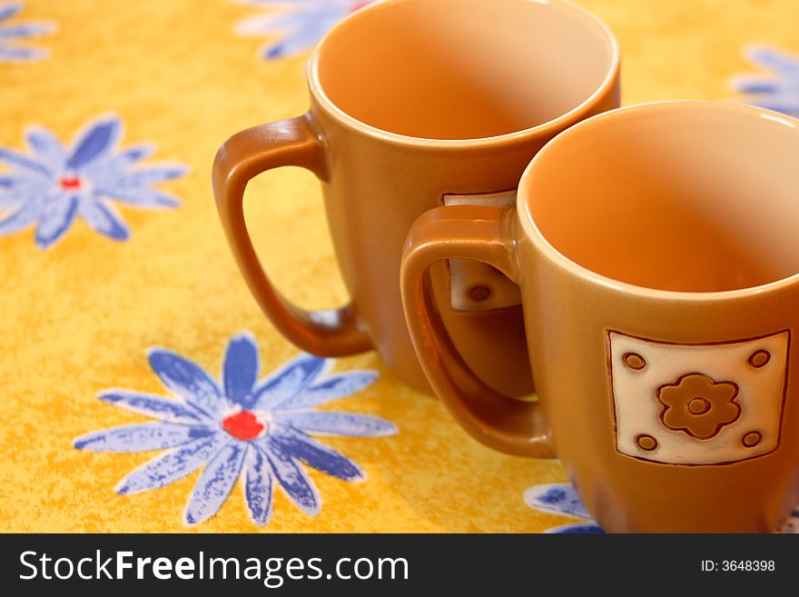 Two empty cups on yellow ground. Two empty cups on yellow ground