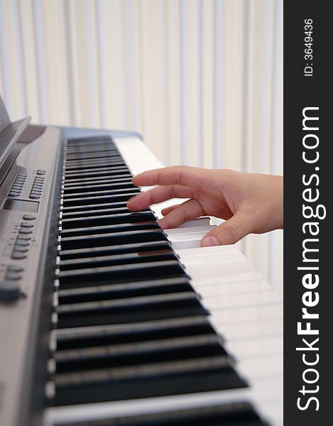 A photo of a hand playing piano