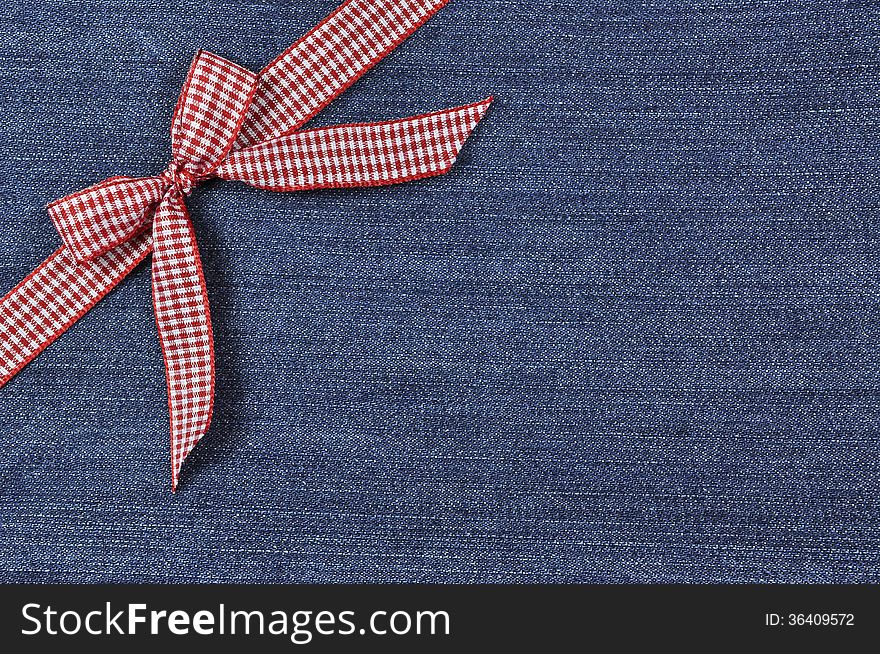 Red Ribbon On A Jeans Background