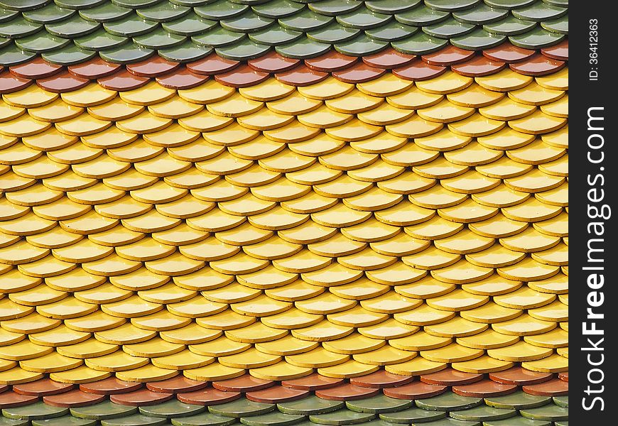 Colorful ancient roof tile of chapel in thai temple