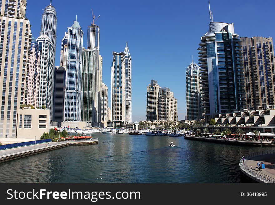 View of Dubai Marina along the sea shore with walking plaza and restaurants, Dubai. UAE.