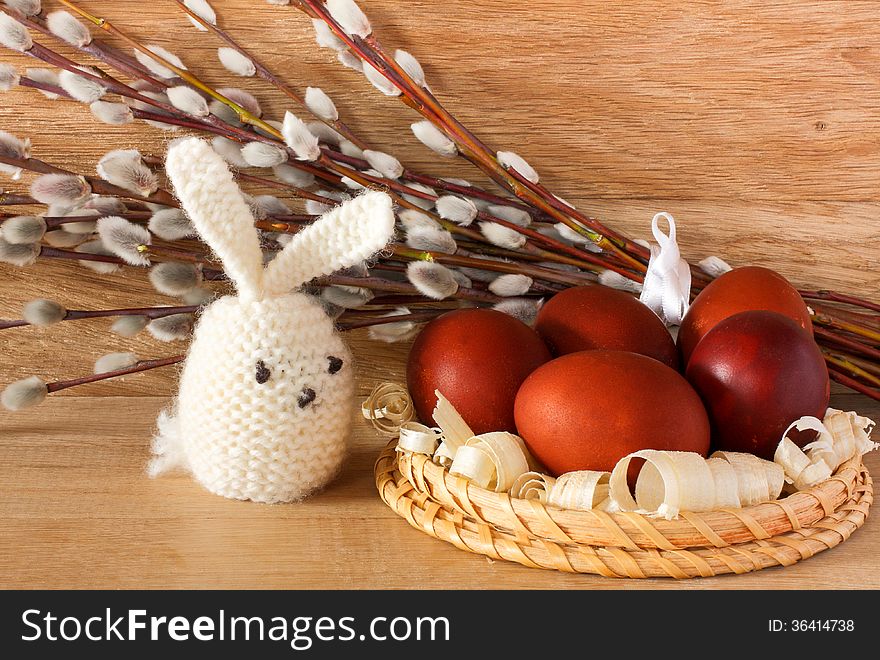 Easter eggs, rabbit and catkins on a wooden background. Easter eggs, rabbit and catkins on a wooden background