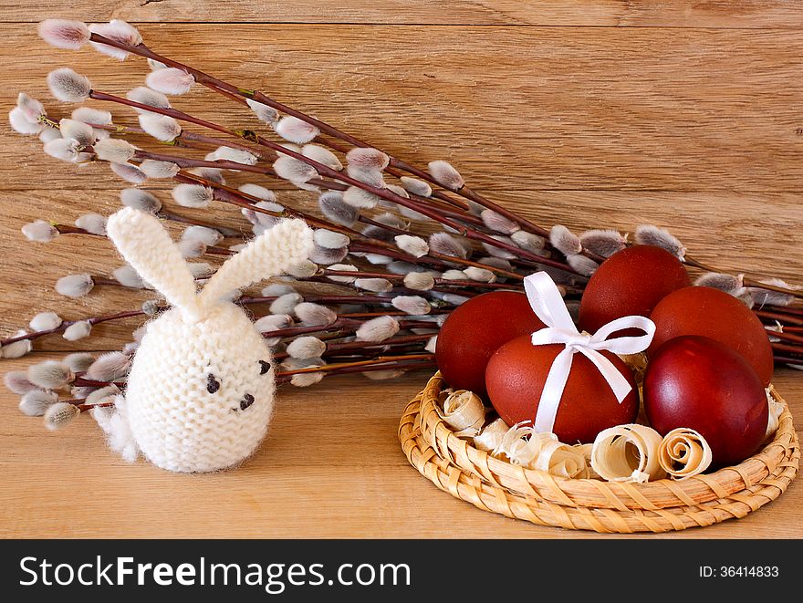 Easter eggs, rabbit and catkins on a wooden background. Easter eggs, rabbit and catkins on a wooden background