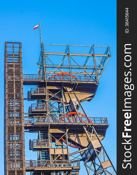 Closeup of the mine shaft with the Polish national flag on the top, in Katowice, Poland.