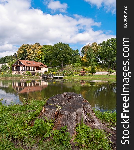 Big Family House In Front Of The Lake In The Forest