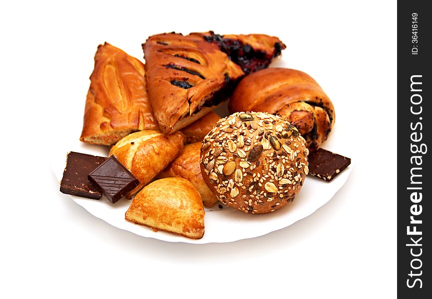 Assorted pastries and pies with filling on isolated background, baking on a white plate. Assorted pastries and pies with filling on isolated background, baking on a white plate