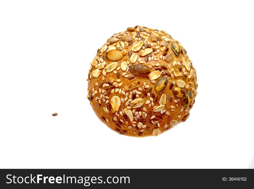 Little bread bun, decorated with grains and cereals on isolated background. Little bread bun, decorated with grains and cereals on isolated background