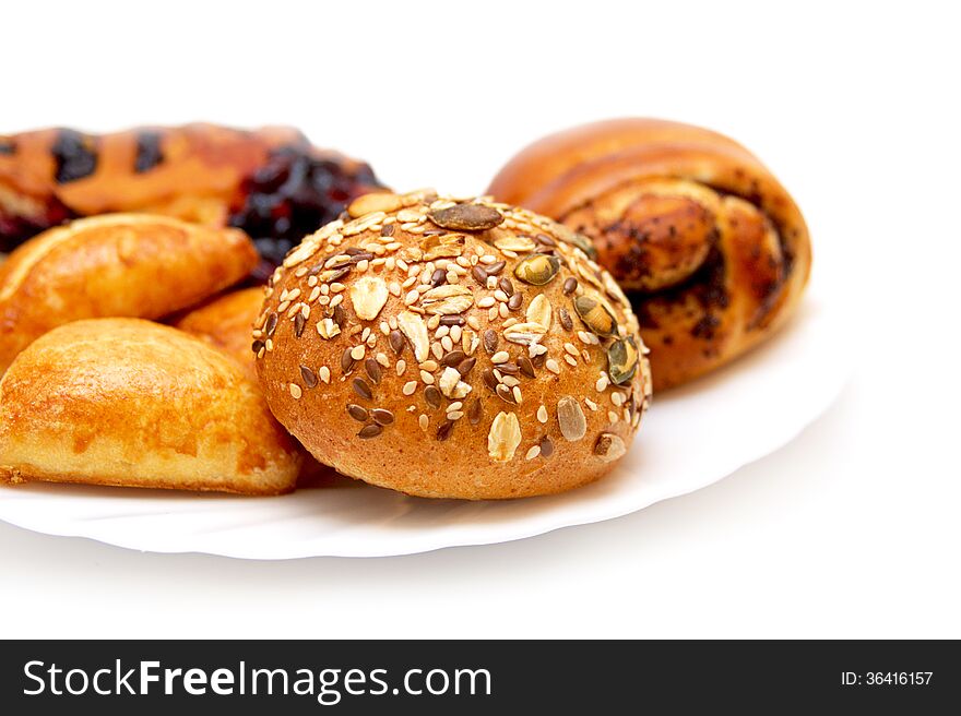 Assorted pastries and pies with filling on isolated background, baking on a white plate. Assorted pastries and pies with filling on isolated background, baking on a white plate