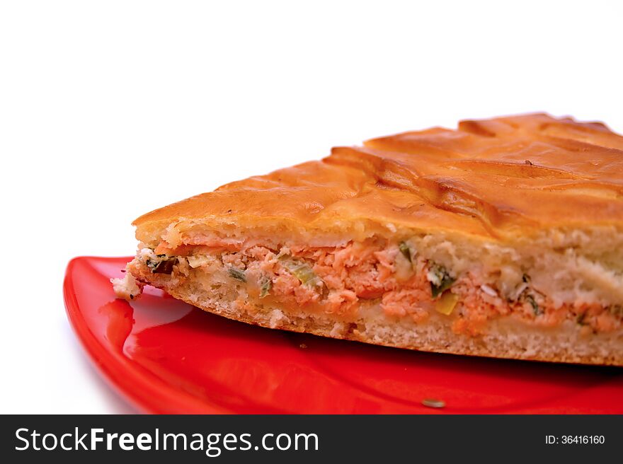 A piece of a fish pie on a red plate original design, isolated background