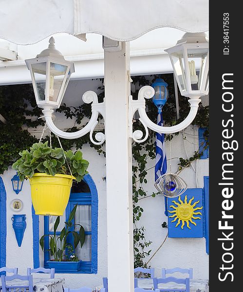 Lantern and flower pot at typical Greek street restaurant, Kos, Greece.