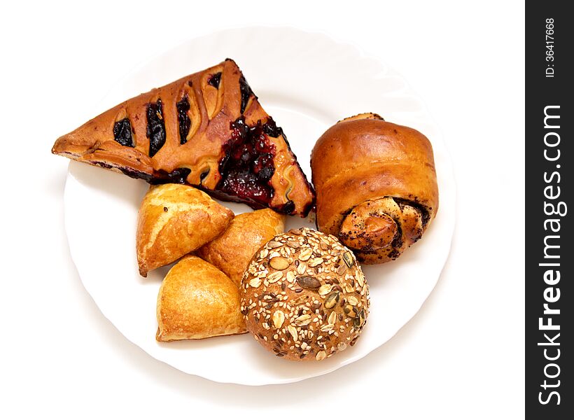 Assorted pastries and pies with filling on isolated background, baking on a white plate baking on a white plate. Assorted pastries and pies with filling on isolated background, baking on a white plate baking on a white plate