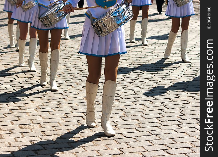 Drummer girls march on city day on sunny summer day