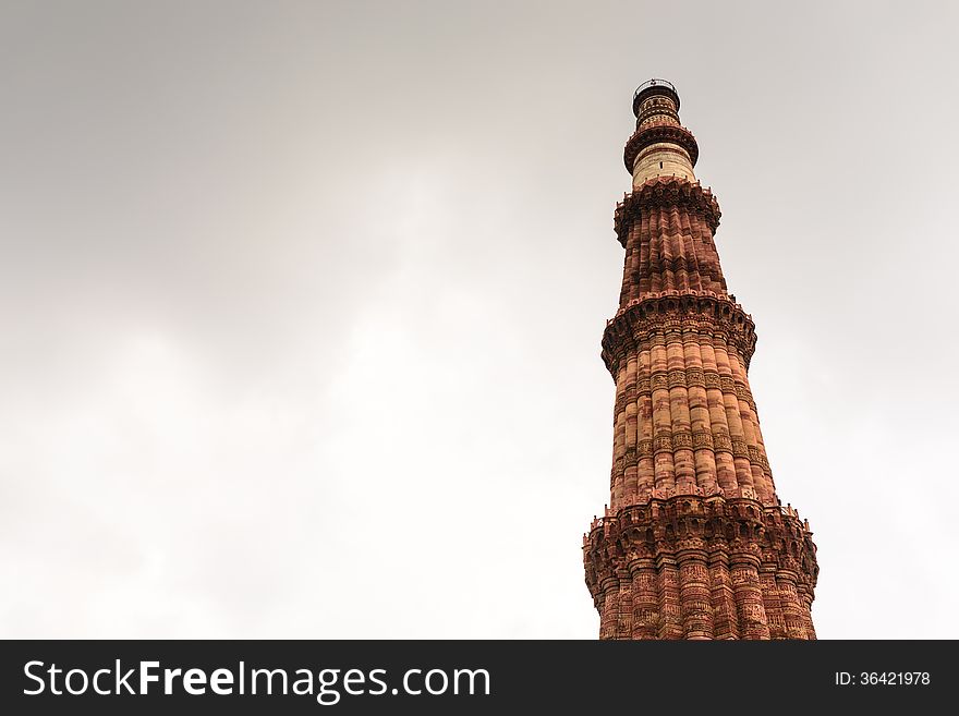 Qutub Minar tower on dull sky,UNESCO World Heritage