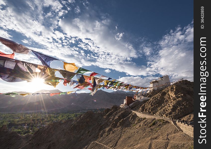 Namgyal Tsemo Gompa with prayer flag with sun ray