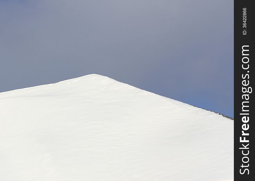 Fresh fallen snow sitting on slated roof. Fresh fallen snow sitting on slated roof